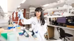 A woman in a white lab coat working at one of Geno’s biotech labs
