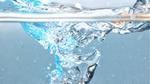 Close-up image of water splashing into a glass