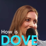 Blonde woman speaking into a microphone beside the text “How is DOVE”