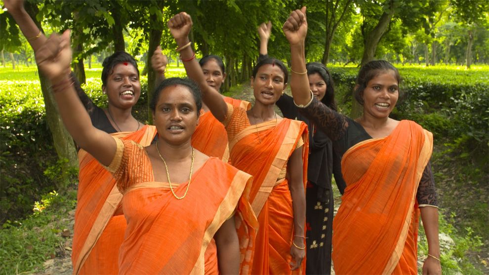 Women workers raising their hands