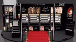 A House of Lakmé beauty counter in India featuring a red carpet and black lacquered furniture.