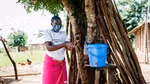 Woman washing her hands outdoors