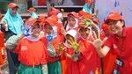 Schoolgirls wearing red Lifebuoy T shirts and caps make palm prints