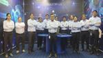 Image of 12 members of the Sonepat factory team standing in front of a blue Industry 4.0 background