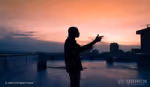 The outline of a man in shadows against the orange light of sunset