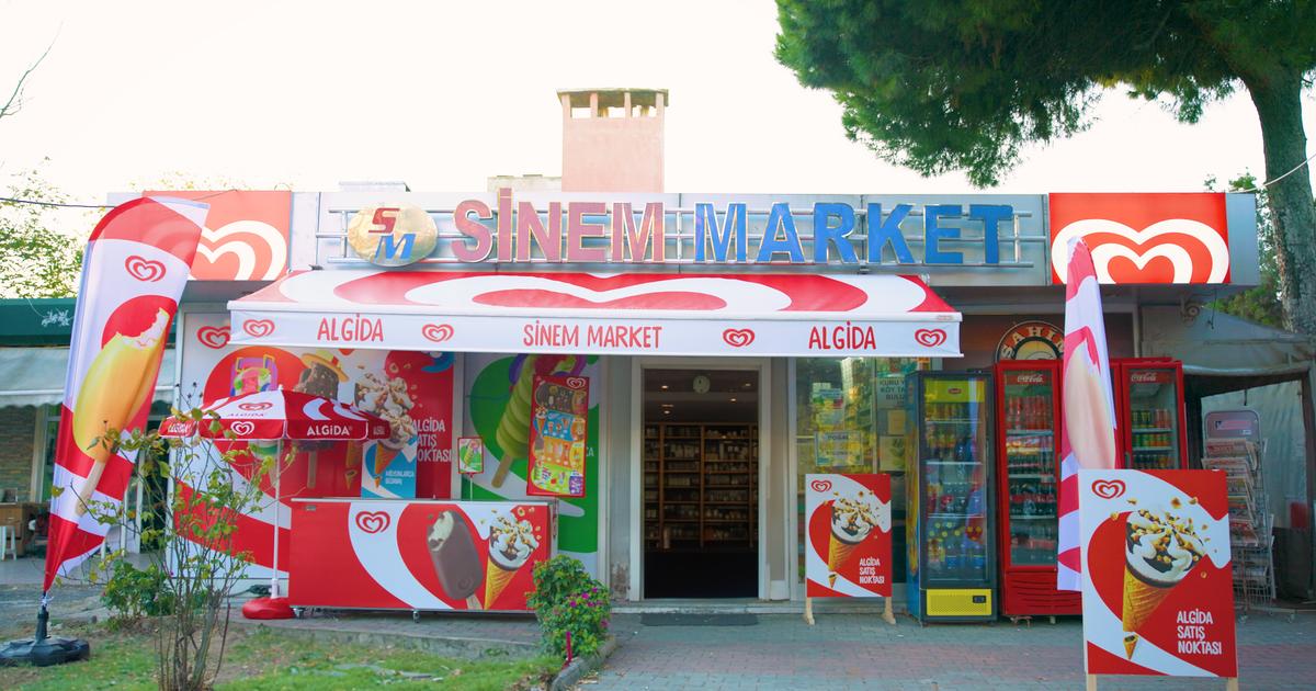 Unilever ice cream freezer cabinets in a retail setting with digital interface elements representing IoT-connected seasonal demand sensing