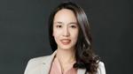 Erica Liang, a scientist at the Pond’s Skin Institute. Erica has long dark hair, a pink blouse and a white lab coat