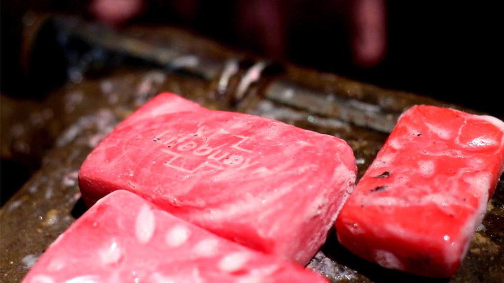 Three Lifebuoy soap bars lathered up
