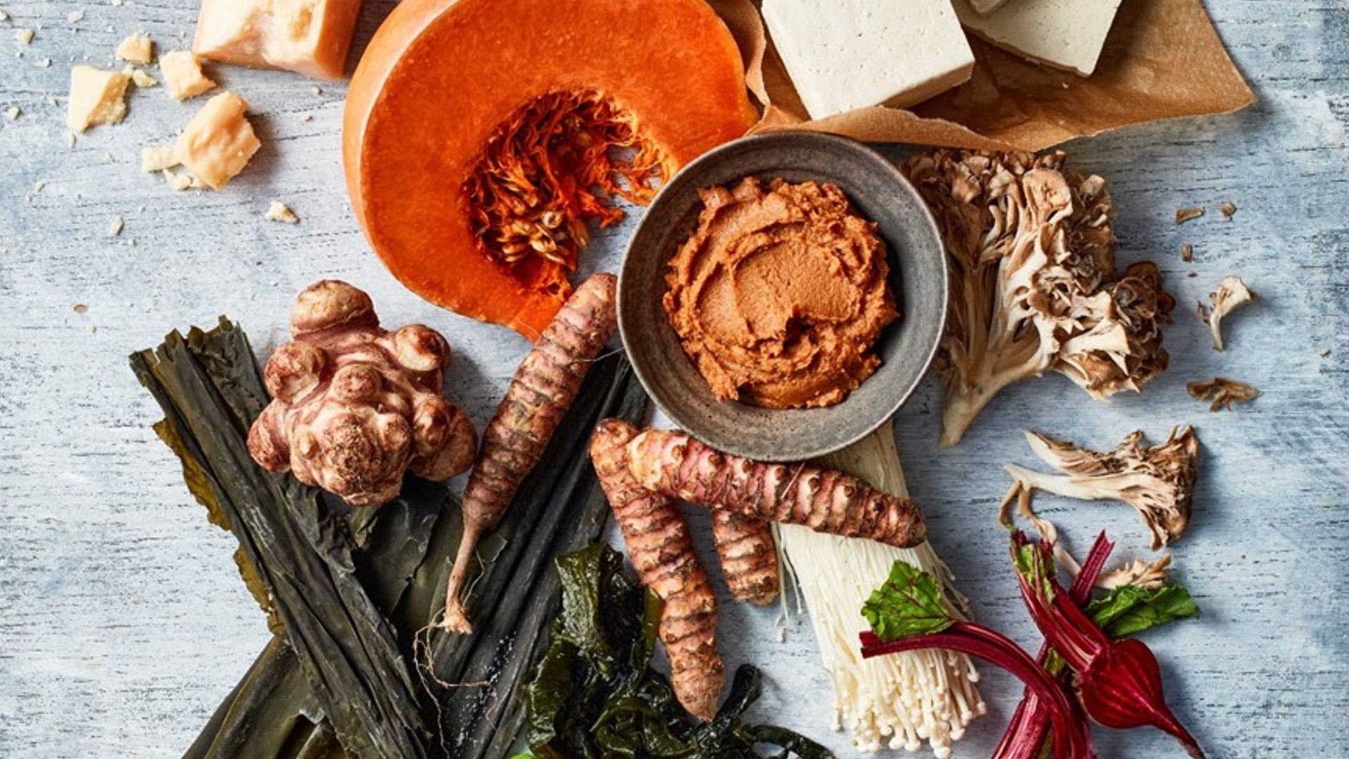A selection of meats and vegetables including tomatoes and celery