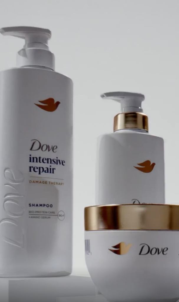 Three different products from the Dove intensive repair range with a white background.