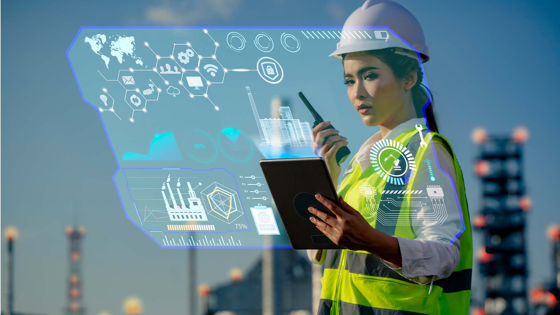 Woman in a hard hat with factory in the background with computer graphics overlaid on the image