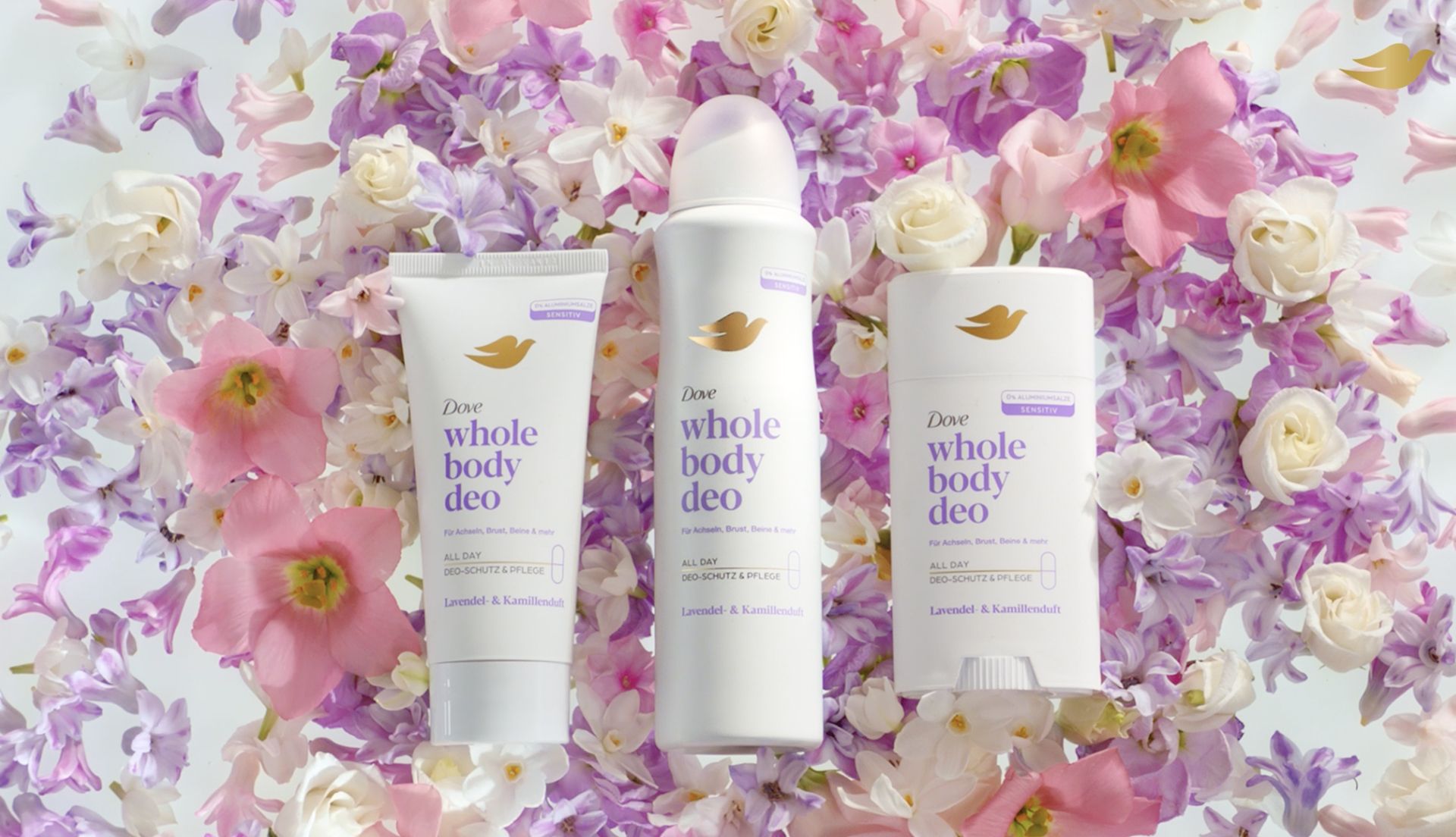 Three Dove Whole Body Deo products arranged on a bed of pastel flowers in shades of pink, purple, and white.