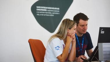 Two employees studying their computer screen at our factory in Brazil