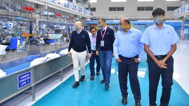 Peter ter Kulve, President of Unilever’s Home Care business group, walking next to a factory production line with member