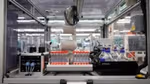 A robot with test tubes in the Materials Innovation Factory.