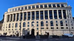 Historic building with columns and large windows under blue sky