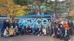 Attendees at the negotiations on a UN treaty to end plastic pollution, posing for a photograph outside the meeting hall.