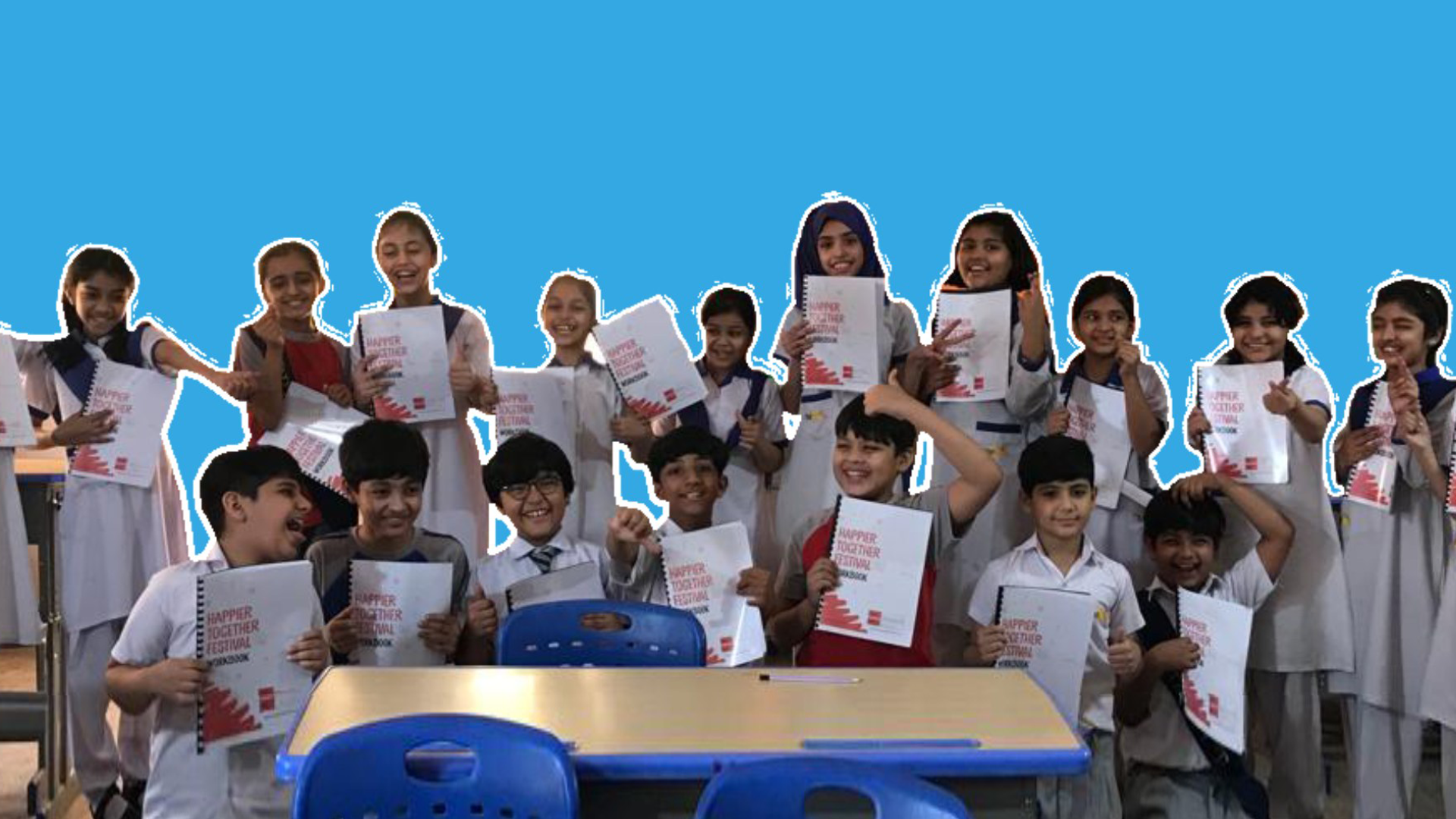 School children smiling and holding up certificates from completing happiness lessons from Wall’s and The Happiness Project