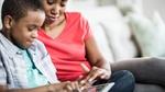 Mother and son working at computer. Hygienica Castle uses online games to teach hygiene lessons to children.