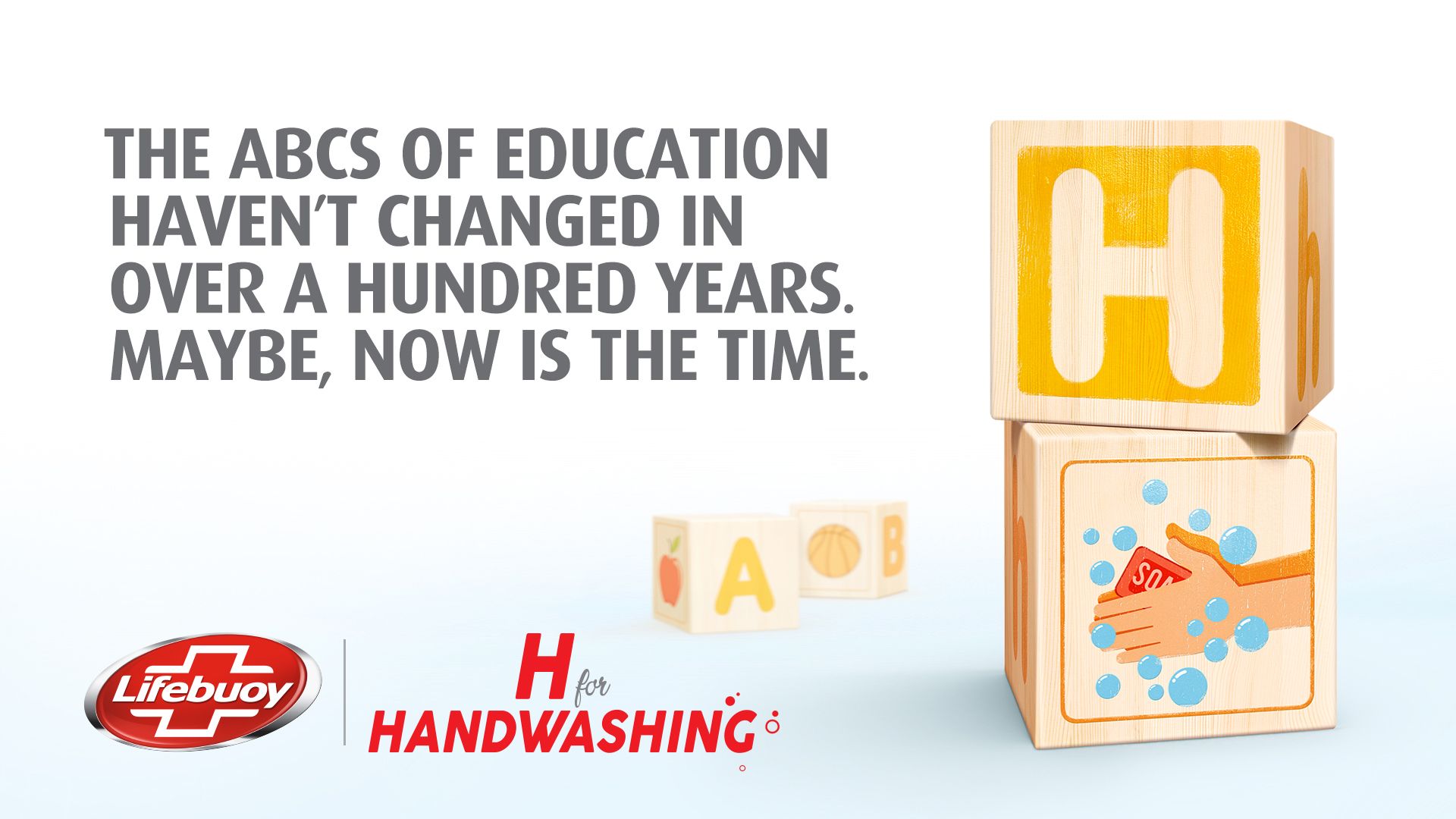 Text on the left of the image says: “The ABCs of education haven’t changed in over a hundred years. Maybe, now is the time.” On the right are two children’s wooden alphabet blocks – one shows the letter ‘H’, the other shows hands and a bar of soap. 