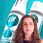 Woman speaking in front of enlarged Cif antibacterial cleaning spray bottles