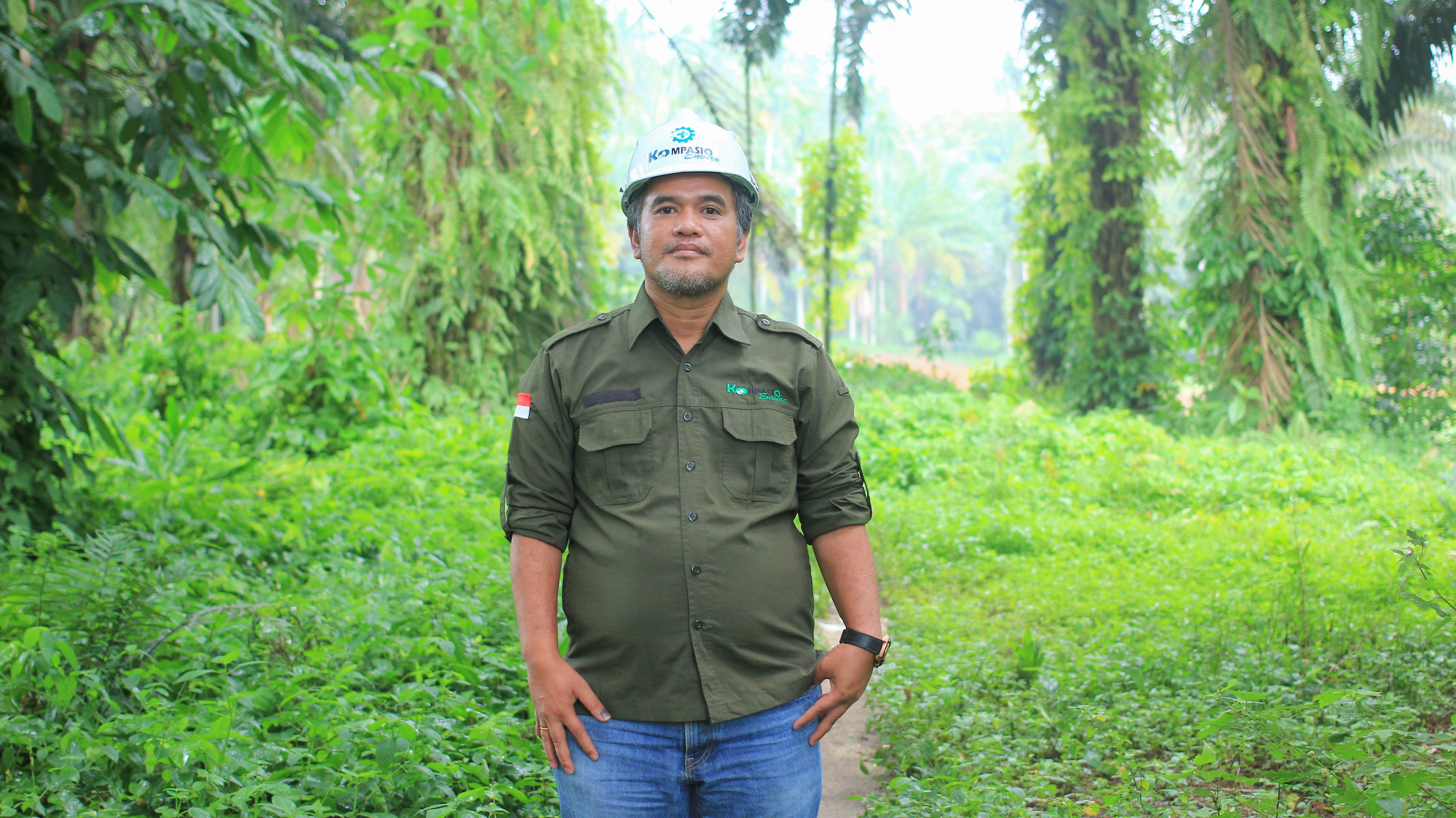 man in hard hat standing in forest
