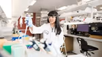 A woman in a white lab coat working at one of Geno’s biotech labs