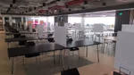 The office canteen where tables and chair have been separated with dividers between them